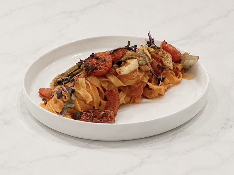 Vegan tagliatelle with tomato and artichoke